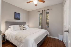 a white bedroom with a bed and a ceiling fan at Silver Springs Retreat in Silver Springs