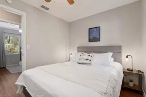 a white bedroom with a large white bed with two pillows at Silver Springs Retreat in Silver Springs +16 photos