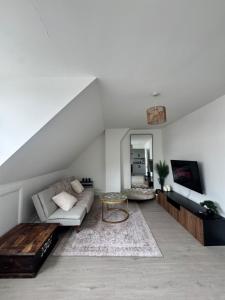 a living room with a couch and a table at Ultra cozy in Brookmans Park