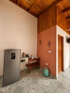 a kitchen with a refrigerator and a table at Hotel Villas Vilma in Fortuna