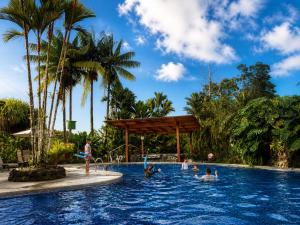 a group of people in a pool at a resort at Hotel Villas Vilma in Fortuna