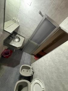 an overhead view of a bathroom with a toilet and a sink at Hispano Argentino in Buenos Aires +12 photos