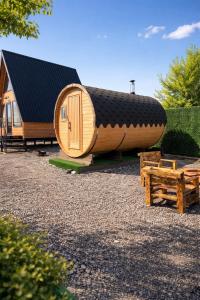 a large wooden cabin with a black roof at Lake Cottages in Grigoleti