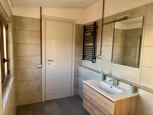 a bathroom with a sink and a mirror at Residenza 33 in Torchiara +36 photos