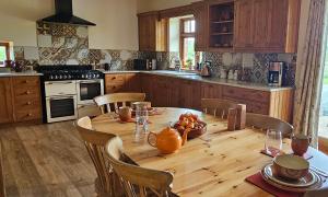 a kitchen with a wooden table with a bowl of fruit on it at The Granary in Barnstaple