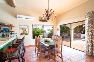 a kitchen and dining room with a table and chairs at Pool Oasis Close to the Beach and Pickleball in Las Palmas