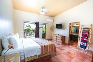 a bedroom with a bed and a television in it at Pool Oasis Close to the Beach and Pickleball in Las Palmas +15 photos