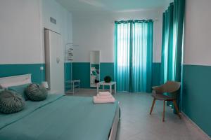 a bedroom with a large bed with a blue wall at Palazzo Ambrosio in Nola