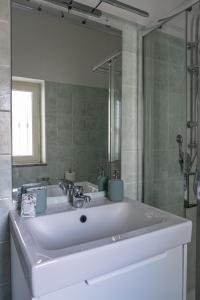 a bathroom with a white sink and a mirror at Palazzo Ambrosio in Nola