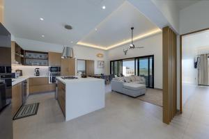 a kitchen and living room with a white counter top at Luxury Villa With Pool in Los Barriles