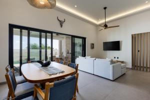 a dining room with a table and a couch at Luxury Villa With Pool in Los Barriles