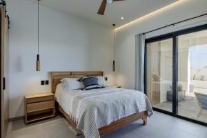 a bedroom with a bed and a sliding glass door at Luxury Villa With Pool in Los Barriles +16 photos