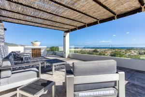 a patio with furniture and a view of the ocean at Luxury Villa With Pool in Los Barriles