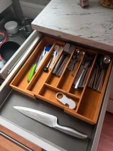 a wooden drawer in a kitchen with utensils at BM Wohnung in Dillingen an der Saar