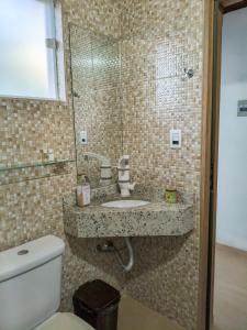 a bathroom with a sink and a toilet at Pousada Vale do Horizonte in Monte Verde +132 photos