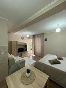 a hotel room with two beds and a table at Apartments Marash in Kotor