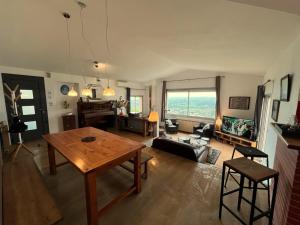 an open living room with a wooden table and chairs at Maison avec piscine et vue panoramique in Albi
