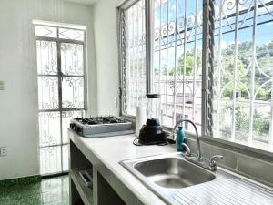 a kitchen with a sink and a window at Casona Tulish, Campeche in Campeche