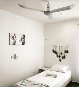 a bedroom with two beds and a ceiling fan at Casona Tulish, Campeche in Campeche