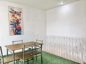 a dining room with a table and chairs and a painting at Casona Tulish, Campeche in Campeche +27 photos