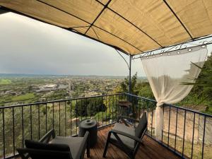 a balcony with chairs and a view of a city at Maison avec piscine et vue panoramique in Albi