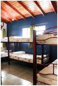 a group of bunk beds in a room at El Camino Hostel in Mina Clavero