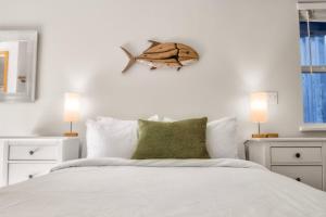 a bedroom with a bed with a fish on the wall at Rising Tide- Cabin In Ucluelet in Ucluelet