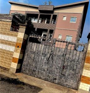an iron gate in front of a building at Executive Delight Suites and Apartments in Magboro-Akeran