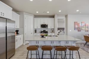 a kitchen with white cabinets and a island with bar stools at Royal Rock Adventures in Washington