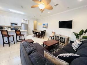 a living room with a couch and a dining room at Family Retreat with pool for 6 Pet Lovers 130 E Retama #3 in South Padre Island