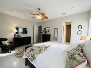 a bedroom with a bed and a ceiling fan at Family Retreat with pool for 6 Pet Lovers 130 E Retama #3 in South Padre Island +17 photos