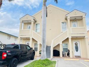 a black truck parked in front of a building at Family Retreat with pool for 6 Pet Lovers 130 E Retama #3 in South Padre Island