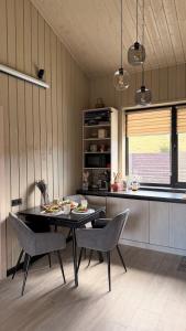 a kitchen with a table and chairs in a room at Гимба in Podobovets +18 photos