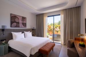 a bedroom with a large bed and a large window at TRIANON Résidence Hôteliere in Marrakesh +79 photos
