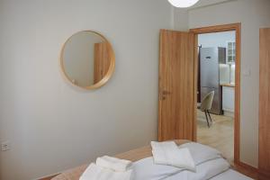 a bedroom with a bed with a mirror on the wall at Datidis Urban Nest in Komotini