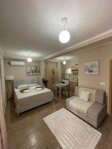 a bedroom with two beds and a couch and a table at Apartments Marash in Kotor