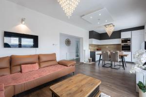 a living room with a couch and a table at Lumina Residence in Sarajevo +106 photos