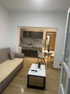a living room with a couch and a table at JS apartmani in Nikšić