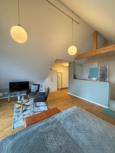 a living room with two chairs and a table at Huus Bellevue in Gleisweiler