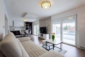 a living room with a couch and a table at Lumina Residence in Sarajevo