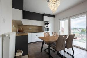 a kitchen and dining room with a table and chairs at Lumina Residence in Sarajevo