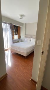 a bedroom with a white bed in a room at Sai in Lima