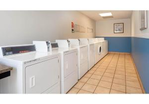 a laundry room with a row of washers and dryers at Motel 6-Anaheim, CA - Maingate in Anaheim