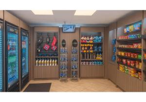 a grocery store aisle with a drink cooler and soda at Motel 6-Anaheim, CA - Maingate in Anaheim