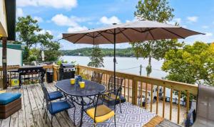 a patio with a table and chairs and an umbrella at The Rubber Duck in Gravois Mills