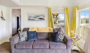 a living room with a couch and yellow curtains at The Rubber Duck in Gravois Mills +25 photos