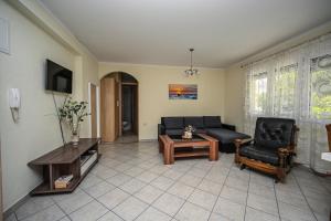 a living room with a couch and a table at Mikuljan Apartments with Pool-5 min to Beach & Private Parking Included in Stobreč