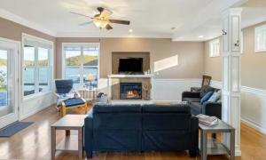 a living room with a blue couch and a fireplace at Amber Waters Hideaway in Camdenton