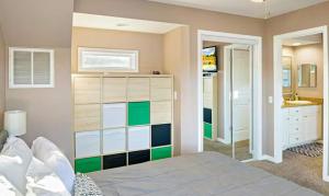 a bedroom with a bed and a bathroom with a sink at Amber Waters Hideaway in Camdenton