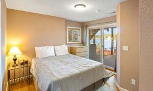 a bedroom with a bed and a sliding glass door at Amber Waters Hideaway in Camdenton